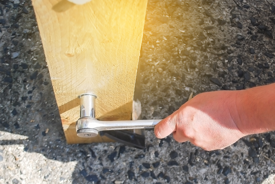 Installing a wooden fence post at a house in Highland Park, Illinois